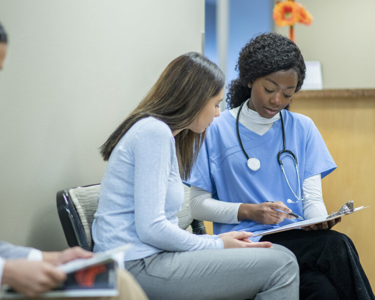 Nurse Talking with a Woman in the Waiting Rom stock photo