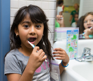 A girl brushes her teeth image